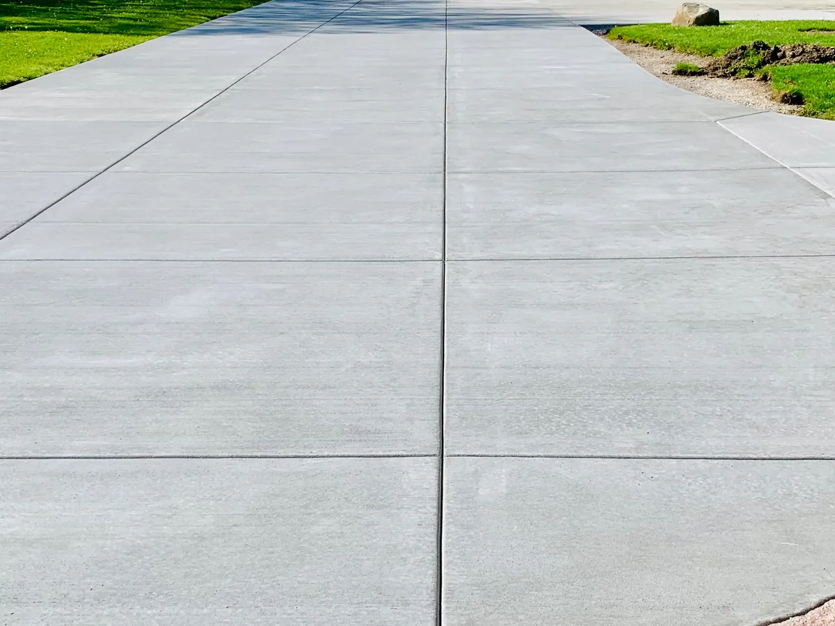 Smooth broom finished concrete slab with clean tooled joints and a crisp edge
