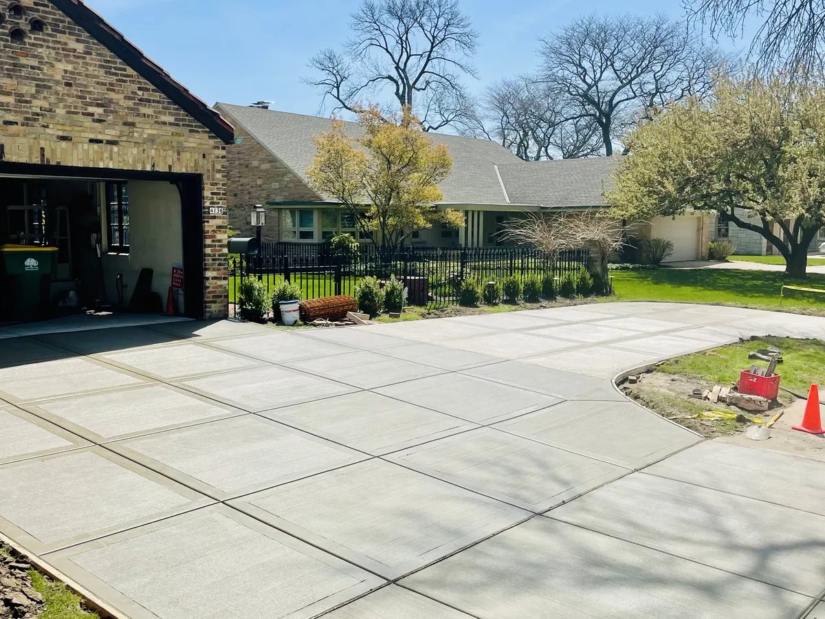 Concrete driveway poured in square panels widening into an apron