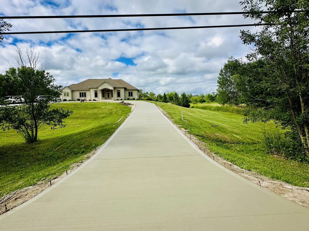 Long curved concrete driveway crossing an open lawn in Milwaukee, Wisconsin